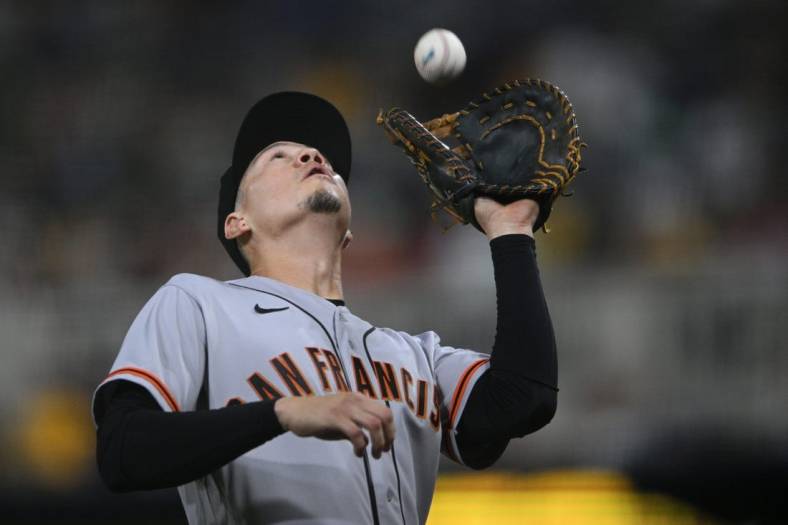 Jul 8, 2022; San Diego, California, USA; San Francisco Giants first baseman Wilmer Flores (41) catches a pop-up in foul territory hit by San Diego Padres right fielder Jose Azocar (not pictured) during the eighth inning at Petco Park. Mandatory Credit: Orlando Ramirez-USA TODAY Sports