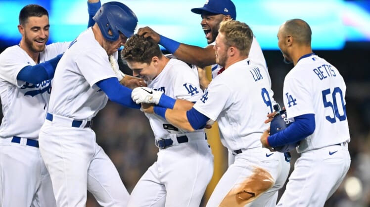 Jul 8, 2022; Los Angeles, California, USA;  Los Angeles Dodgers catcher Will Smith (middle) is mobbed by center fielder Cody Bellinger (35), first baseman Freddie Freeman (5), second baseman Hanser Alberto (17), left fielder Gavin Lux (9) and right fielder Mookie Betts (50) after hitting a walk off RBI single to defeat the Chicago Cubs in the 10th inning at Dodger Stadium. Mandatory Credit: Jayne Kamin-Oncea-USA TODAY Sports