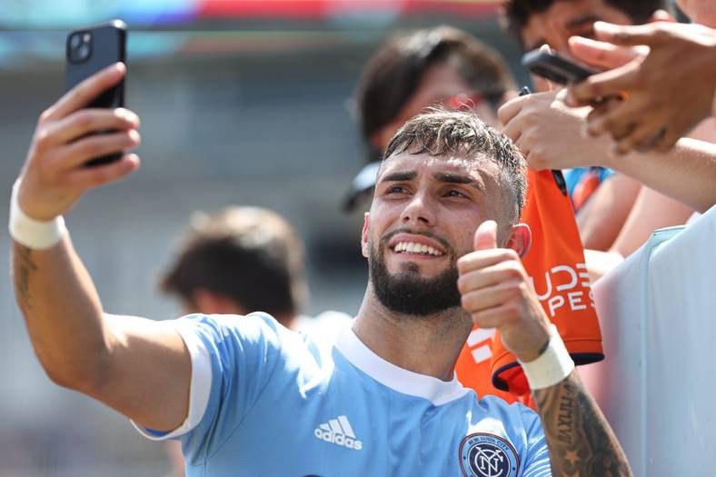 Jul 9, 2022; New York, New York, USA; New York City FC forward Valentin Castellanos (11) takes a selfie with fans after the game against the New England Revolution at Yankee Stadium. Mandatory Credit: Vincent Carchietta-USA TODAY Sports