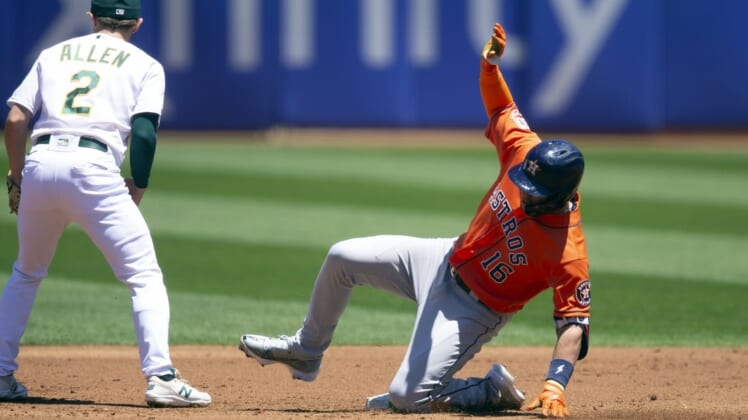 Jul 9, 2022; Oakland, California, USA; Houston Astros designated hitter Aledmys D  az (16) slides safely into second base while Oakland Athletics second baseman Nick Allen (2) waits for the late relay during the second inning at RingCentral Coliseum. Mandatory Credit: D. Ross Cameron-USA TODAY Sports