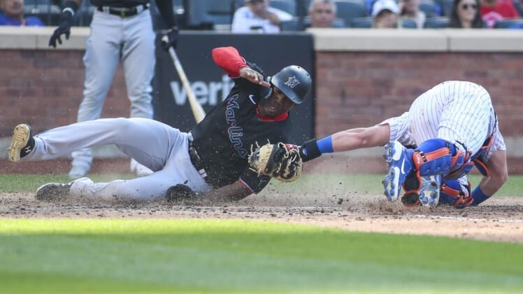 Jul 9, 2022; New York City, New York, USA;  Miami Marlins center fielder Jesus Sanchez (7) is tagged out at home by New York Mets catcher James McCann (33) in the sixth inning at Citi Field. Mandatory Credit: Wendell Cruz-USA TODAY Sports