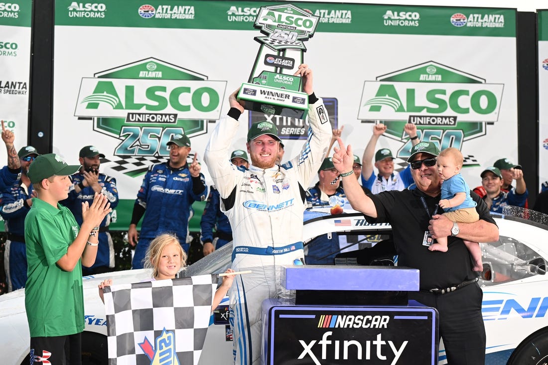 Jul 9, 2022; Hampton, Georgia, USA; NASCAR Xfinity Series driver Austin Hill (21) celebrates with the trophy after winning the Alsco Uniforms 250 at Atlanta Motor Speedway. Mandatory Credit: Adam Hagy-USA TODAY Sports