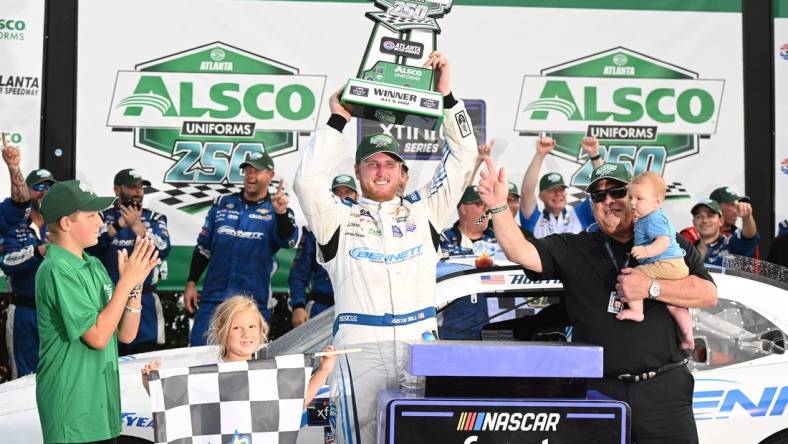 Jul 9, 2022; Hampton, Georgia, USA; NASCAR Xfinity Series driver Austin Hill (21) celebrates with the trophy after winning the Alsco Uniforms 250 at Atlanta Motor Speedway. Mandatory Credit: Adam Hagy-USA TODAY Sports