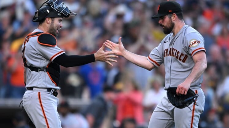 Jul 9, 2022; San Diego, California, USA; San Francisco Giants starting pitcher Carlos Rodon (right) celebrates with catcher Austin Wynns (left) after the Giants defeated the San Diego Padres at Petco Park. Mandatory Credit: Orlando Ramirez-USA TODAY Sports