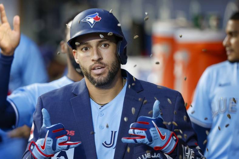 Jul 9, 2022; Seattle, Washington, USA; Toronto Blue Jays center fielder George Springer (4) celebrates in the dugout after hitting a solo-home run against the Seattle Mariners during the sixth inning at T-Mobile Park. Mandatory Credit: Joe Nicholson-USA TODAY Sports