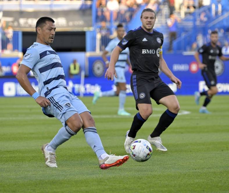 Jul 9, 2022; Montreal, Quebec, CAN; Sporting Kansas City midfielder Roger Espinoza (15) plays the ball and CF Montreal midfielder Samuel Piette (6) defends during the first half at Stade Saputo. Mandatory Credit: Eric Bolte-USA TODAY Sports
