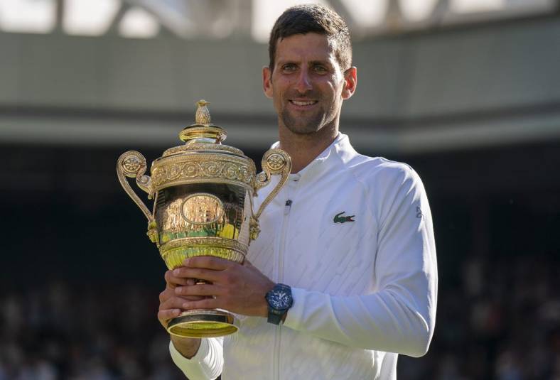 Jul 10, 2022; London, United Kingdom; Novak Djokovic (SRB) poses with the trophy after winning the men's final against Nick Kyrgios (not pictured) on day 14 at All England Lawn Tennis and Croquet Club. Mandatory Credit: Susan Mullane-USA TODAY Sports