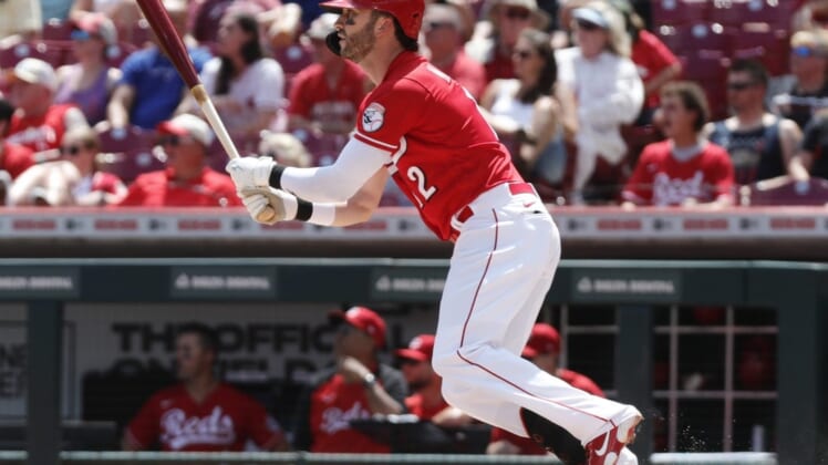 Jul 10, 2022; Cincinnati, Ohio, USA; Cincinnati Reds right fielder Tyler Naquin (12) hits a two-run double against the Tampa Bay Rays during the fourth inning at Great American Ball Park. Mandatory Credit: David Kohl-USA TODAY Sports