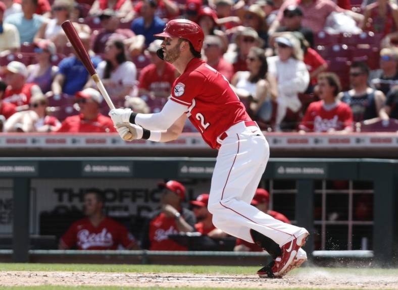 Jul 10, 2022; Cincinnati, Ohio, USA; Cincinnati Reds right fielder Tyler Naquin (12) hits a two-run double against the Tampa Bay Rays during the fourth inning at Great American Ball Park. Mandatory Credit: David Kohl-USA TODAY Sports