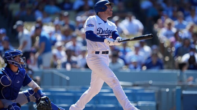 Jul 10, 2022; Los Angeles, California, USA; Los Angeles Dodgers first baseman Freddie Freeman (5) follows through on a solo home run in the sixth inning against the Chicago Cubs at Dodger Stadium. Mandatory Credit: Kirby Lee-USA TODAY Sports