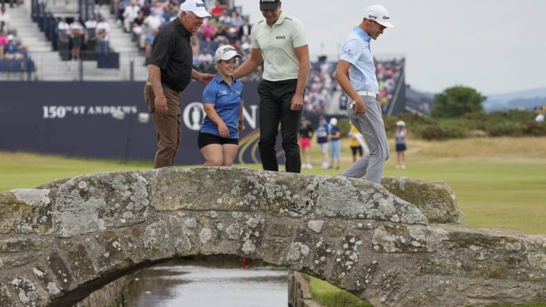 Jul 11, 2022; St. Andrews, Fife, SCT; Mark O'meara (left) Jennifer Sraga (center left) Henrik Stenson and Aaron Jarvis on the Swilcan Bridge on the 18th fairway during the Celebration of Champions at the 150th Open Championship golf tournament at St. Andrews Old Course. Mandatory Credit: Michael Madrid-USA TODAY Sports