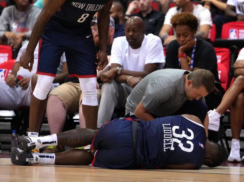 Jul 11, 2022; Las Vegas, NV, USA; New Orleans Pelicans forward E.J. Liddell (32) suffers an apparent injury during an NBA Summer League game against the Atlanta Hawks at Cox Pavilion. Mandatory Credit: Stephen R. Sylvanie-USA TODAY Sports