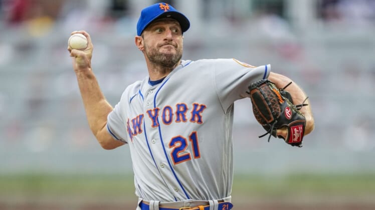 Jul 11, 2022; Cumberland, Georgia, USA; New York Mets starting pitcher Max Scherzer (21) pitches against the Atlanta Braves during the first inning at Truist Park. Mandatory Credit: Dale Zanine-USA TODAY Sports