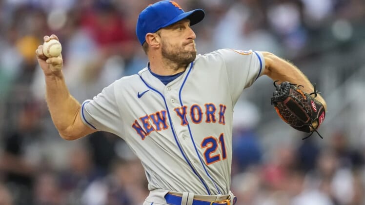 Jul 11, 2022; Cumberland, Georgia, USA; New York Mets starting pitcher Max Scherzer (21) pitches against the Atlanta Braves during the third inning at Truist Park. Mandatory Credit: Dale Zanine-USA TODAY Sports