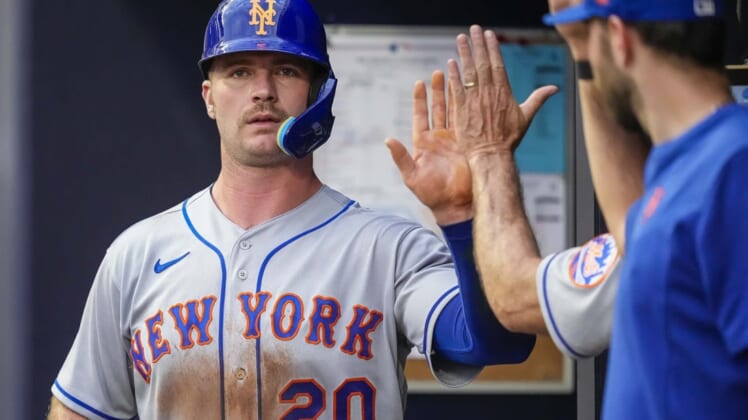 Jul 11, 2022; Cumberland, Georgia, USA; New York Mets first baseman Pete Alonso (20) gets a high five in the dugout after scoring a run against the Atlanta Braves during the third inning at Truist Park. Mandatory Credit: Dale Zanine-USA TODAY Sports