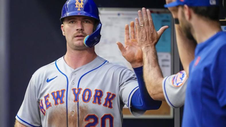 Jul 11, 2022; Cumberland, Georgia, USA; New York Mets first baseman Pete Alonso (20) gets a high five in the dugout after scoring a run against the Atlanta Braves during the third inning at Truist Park. Mandatory Credit: Dale Zanine-USA TODAY Sports