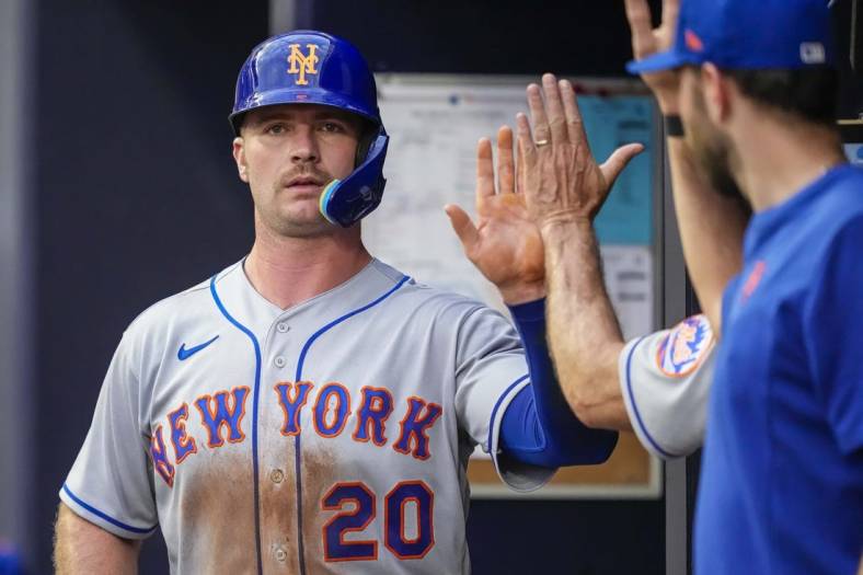 Jul 11, 2022; Cumberland, Georgia, USA; New York Mets first baseman Pete Alonso (20) gets a high five in the dugout after scoring a run against the Atlanta Braves during the third inning at Truist Park. Mandatory Credit: Dale Zanine-USA TODAY Sports