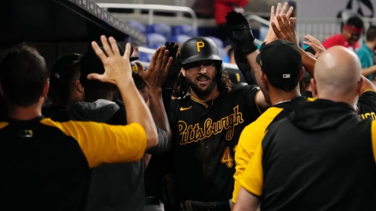 Jul 11, 2022; Miami, Florida, USA; Pittsburgh Pirates center fielder Jake Marisnick (41) celebrates with teammates in the dugout after hitting a two-run home run in the ninth inning against the Miami Marlins at loanDepot park. Mandatory Credit: Jasen Vinlove-USA TODAY Sports