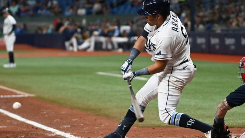 Jul 11, 2022; St. Petersburg, Florida, USA; Tampa Bay Rays second baseman Jonathan Aranda (62) hits a RBI single in the second inning against the Boston Red Sox at Tropicana Field. Mandatory Credit: Jonathan Dyer-USA TODAY Sports