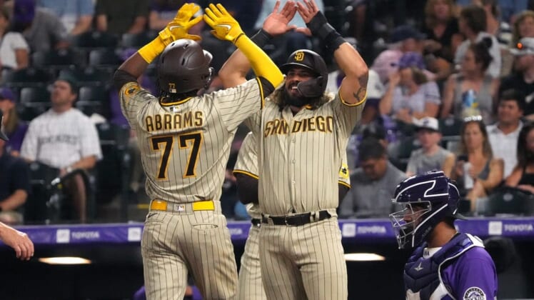 Jul 11, 2022; Denver, Colorado, USA; San Diego Padres shortstop C.J. Abrams (77) celebrates his three-run home run with catcher Jorge Alfaro (38) in the seventh inning against the Colorado Rockies at Coors Field. Mandatory Credit: Ron Chenoy-USA TODAY Sports