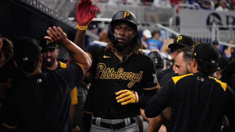 Jul 12, 2022; Miami, Florida, USA; Pittsburgh Pirates shortstop Oneil Cruz (15) celebrates in the dugout after scoring a run in the fifth inning against the Miami Marlins at loanDepot park. Mandatory Credit: Jasen Vinlove-USA TODAY Sports