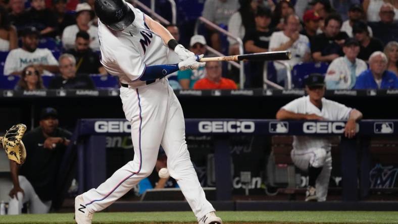 Jul 12, 2022; Miami, Florida, USA; Miami Marlins first baseman Garrett Cooper (26) fouls a pitch off his knee in the sixth inning against the Pittsburgh Pirates, cooper would leave the game with an apparent injury between innings at loanDepot park. Mandatory Credit: Jasen Vinlove-USA TODAY Sports