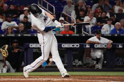 Jul 12, 2022; Miami, Florida, USA; Miami Marlins first baseman Garrett Cooper (26) fouls a pitch off his knee in the sixth inning against the Pittsburgh Pirates, cooper would leave the game with an apparent injury between innings at loanDepot park. Mandatory Credit: Jasen Vinlove-USA TODAY Sports
