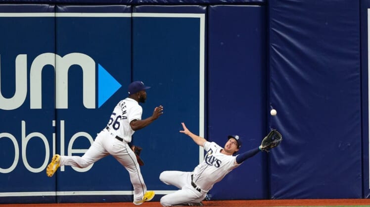 Jul 12, 2022; St. Petersburg, Florida, USA; Tampa Bay Rays shortstop Taylor Walls (right) dives for a ball in the fifth inning against the Boston Red Sox at Tropicana Field. Mandatory Credit: Nathan Ray Seebeck-USA TODAY Sports