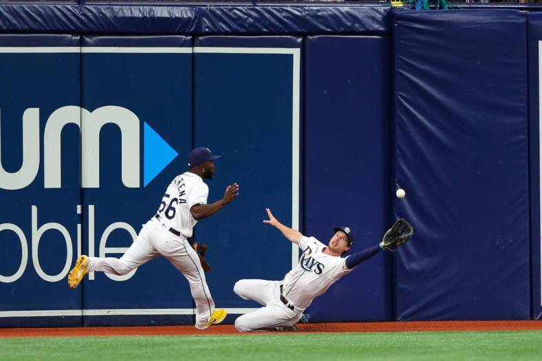 Jul 12, 2022; St. Petersburg, Florida, USA; Tampa Bay Rays shortstop Taylor Walls (right) dives for a ball in the fifth inning against the Boston Red Sox at Tropicana Field. Mandatory Credit: Nathan Ray Seebeck-USA TODAY Sports
