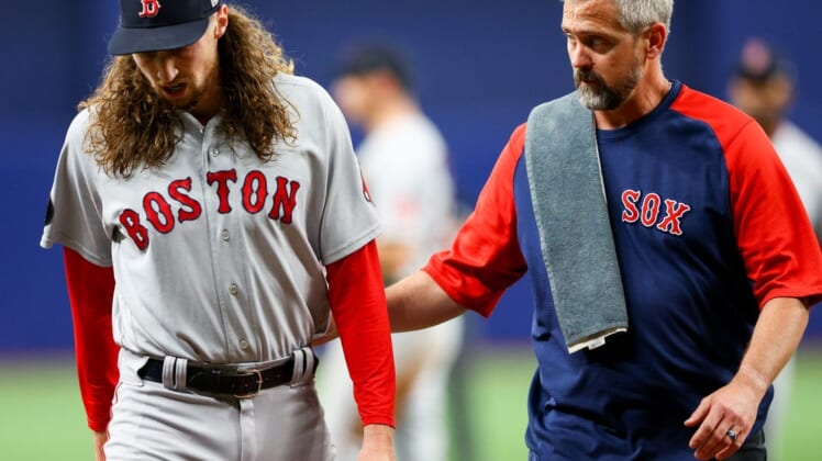 Jul 12, 2022; St. Petersburg, Florida, USA; Boston Red Sox relief pitcher Matt Strahm (left) leaves the game after getting hit by a line drive in the sixth inning against the Tampa Bay Rays at Tropicana Field. Mandatory Credit: Nathan Ray Seebeck-USA TODAY Sports