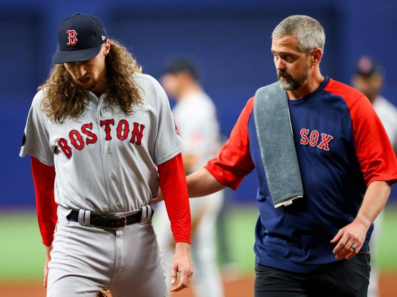 Jul 12, 2022; St. Petersburg, Florida, USA; Boston Red Sox relief pitcher Matt Strahm (left) leaves the game after getting hit by a line drive in the sixth inning against the Tampa Bay Rays at Tropicana Field. Mandatory Credit: Nathan Ray Seebeck-USA TODAY Sports