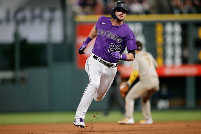 Jul 12, 2022; Denver, Colorado, USA; Colorado Rockies left fielder Sam Hilliard (22) runs to third on a fielding error from the San Diego Padres in the seventh inning at Coors Field. Mandatory Credit: Isaiah J. Downing-USA TODAY Sports