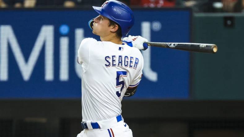 Jul 12, 2022; Arlington, Texas, USA; Texas Rangers shortstop Corey Seager (5) hits a home run during the ninth inning against the Oakland Athletics at Globe Life Field. Mandatory Credit: Kevin Jairaj-USA TODAY Sports