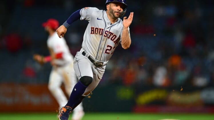 Jul 12, 2022; Anaheim, California, USA; Houston Astros second baseman Jose Altuve (27) runs to third against the Los Angeles Angels during the ninth inning at Angel Stadium. Mandatory Credit: Gary A. Vasquez-USA TODAY Sports