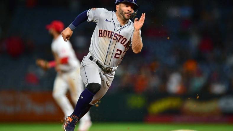 Jul 12, 2022; Anaheim, California, USA; Houston Astros second baseman Jose Altuve (27) runs to third against the Los Angeles Angels during the ninth inning at Angel Stadium. Mandatory Credit: Gary A. Vasquez-USA TODAY Sports