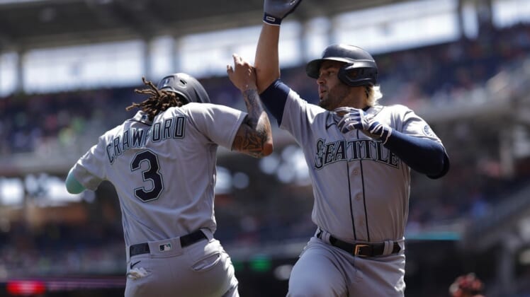 Jul 13, 2022; Washington, District of Columbia, USA; Seattle Mariners third baseman Eugenio Suarez (28) celebrates with Mariners shortstop J.P. Crawford (3) after hitting a three run home run against the Washington Nationals during the first inning at Nationals Park. Mandatory Credit: Geoff Burke-USA TODAY Sports