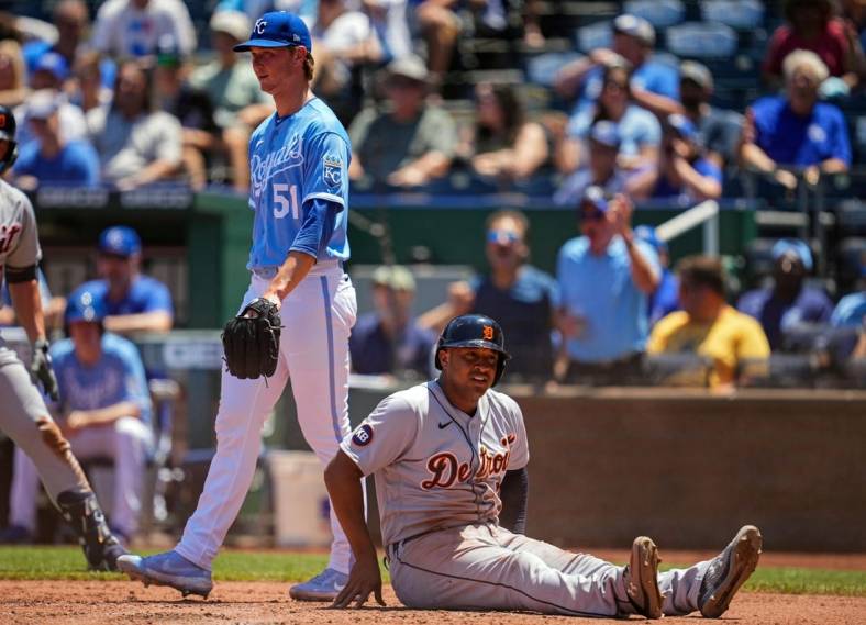 Jul 13, 2022; Kansas City, Missouri, USA; Detroit Tigers second baseman Jonathan Schoop (7) reacts after being tagged out at home plate as Kansas City Royals starting pitcher Brady Singer (51) looks on during the fourth inning at Kauffman Stadium. Mandatory Credit: Jay Biggerstaff-USA TODAY Sports