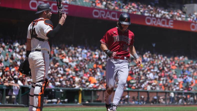 Jul 13, 2022; San Francisco, California, USA; Arizona Diamondbacks center fielder Jake McCarthy (30) scores a run during the second inning against the San Francisco Giants at Oracle Park. Mandatory Credit: Sergio Estrada-USA TODAY Sports