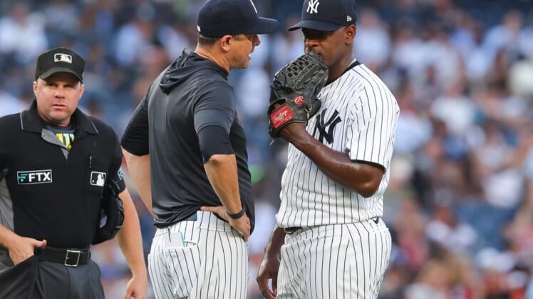 Jul 13, 2022; Bronx, New York, USA; New York Yankees manager Aaron Boone (17) talks with starting pitcher Luis Severino (40) during the second inning against the Cincinnati Reds at Yankee Stadium. Mandatory Credit: Vincent Carchietta-USA TODAY Sports