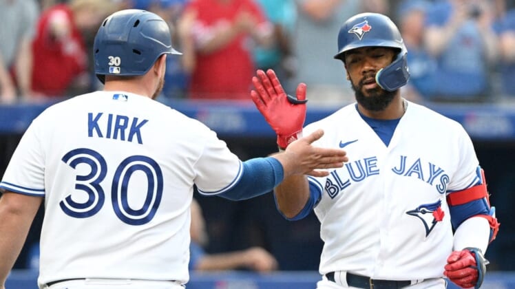 Jul 13, 2022; Toronto, Ontario, CAN; Toronto Blue Jays right fielder Teoscar Hernandez (right) is greeted at home plate by catcher Alejandro Kirk (30) after hitting a two-run home run against the Philadelphia Phillies in the fourth inning at Rogers Centre. Mandatory Credit: Dan Hamilton-USA TODAY Sports