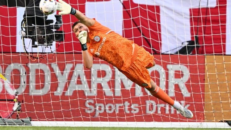 Jul 13, 2022; Chicago, Illinois, USA;  Chicago Fire FC goalkeeper Gaga Slonina (1) redirects a Toronto FC shot away from the net with his fingertips in the first half at Soldier Field. Mandatory Credit: Jamie Sabau-USA TODAY Sports
