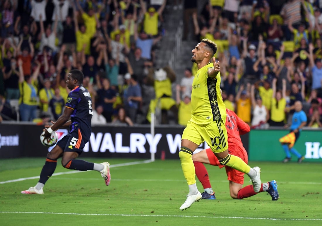 Jul 13, 2022; Nashville, Tennessee, USA; Nashville SC midfielder Hany Mukhtar (10) celebrates after a goal during the first half against the Seattle Sounders at GEODIS Park. Mandatory Credit: Christopher Hanewinckel-USA TODAY Sports