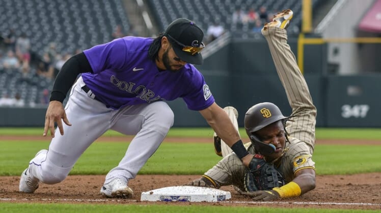 Jul 13, 2022; Denver, Colorado, USA; San Diego Padres shortstop C.J. Abrams (right) is picked off at first base by Colorado Rockies first baseman Connor Joe (left) in the second inning at Coors Field. Mandatory Credit: John Leyba-USA TODAY Sports