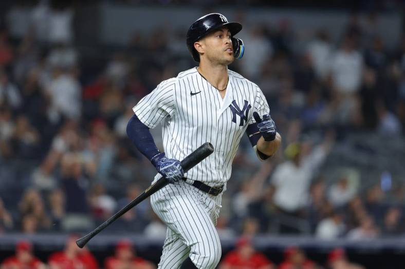 Jul 13, 2022; Bronx, New York, USA; New York Yankees right fielder Giancarlo Stanton (27) looks up at his solo home run during the eighth inning against the Cincinnati Reds at Yankee Stadium. Mandatory Credit: Vincent Carchietta-USA TODAY Sports