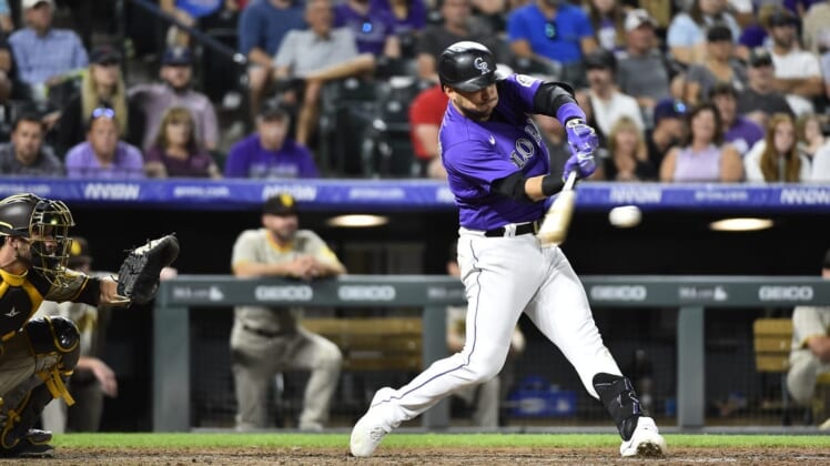 Jul 13, 2022; Denver, Colorado, USA; Colorado Rockies shortstop Jose Iglesias (11) hits a two run RBI in the seventh inning against the San Diego Padres at Coors Field. Iglesias ended the game with a 6 RBI night. Mandatory Credit: John Leyba-USA TODAY Sports