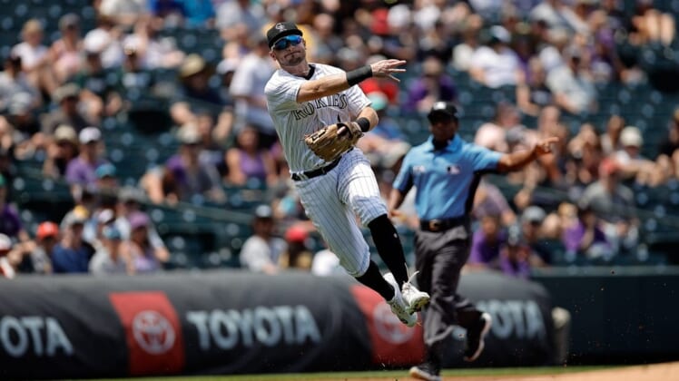 Jul 14, 2022; Denver, Colorado, USA; Colorado Rockies third baseman Garrett Hampson (1) makes a throw to first for an out in the first inning against the San Diego Padres at Coors Field. Mandatory Credit: Isaiah J. Downing-USA TODAY Sports