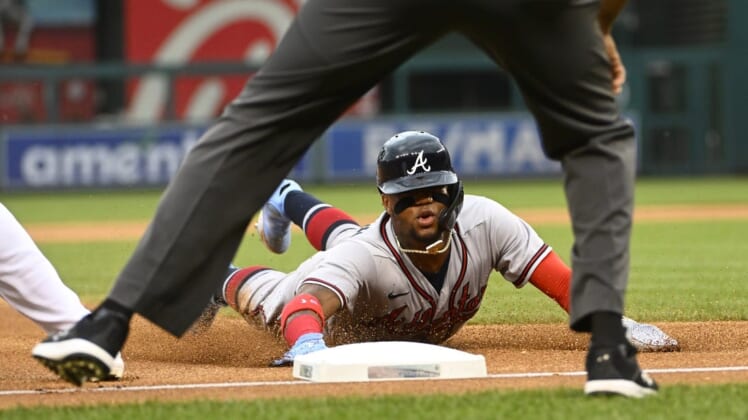 Jul 14, 2022; Washington, District of Columbia, USA; Atlanta Braves right fielder Ronald Acuna Jr. (13) slides into third base during the first inning against the Washington Nationals at Nationals Park. Mandatory Credit: Brad Mills-USA TODAY Sports