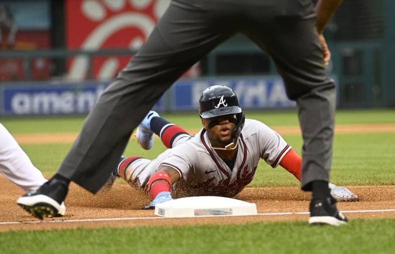 Jul 14, 2022; Washington, District of Columbia, USA; Atlanta Braves right fielder Ronald Acuna Jr. (13) slides into third base during the first inning against the Washington Nationals at Nationals Park. Mandatory Credit: Brad Mills-USA TODAY Sports