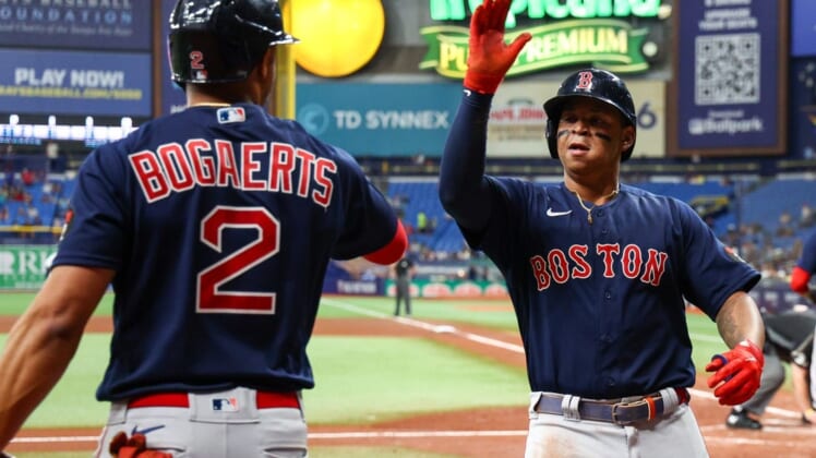 Jul 14, 2022; St. Petersburg, Florida, USA;  Boston Red Sox third baseman Rafael Devers (11) is congratulated by shortstop Xander Bogaerts (2) after hitting a home run against the Tampa Bay Rays in the fourth inning at Tropicana Field. Mandatory Credit: Nathan Ray Seebeck-USA TODAY Sports