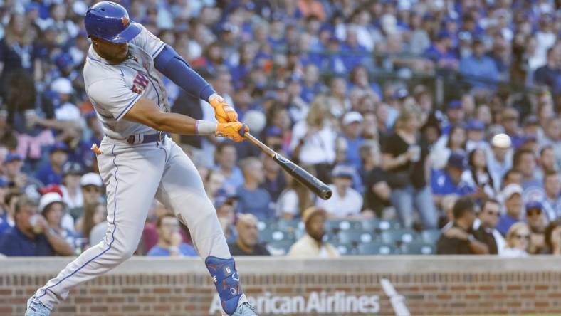 Jul 14, 2022; Chicago, Illinois, USA; New York Mets right fielder Starling Marte (6) hits an RBI-single against the Chicago Cubs during the second inning at Wrigley Field. Mandatory Credit: Kamil Krzaczynski-USA TODAY Sports